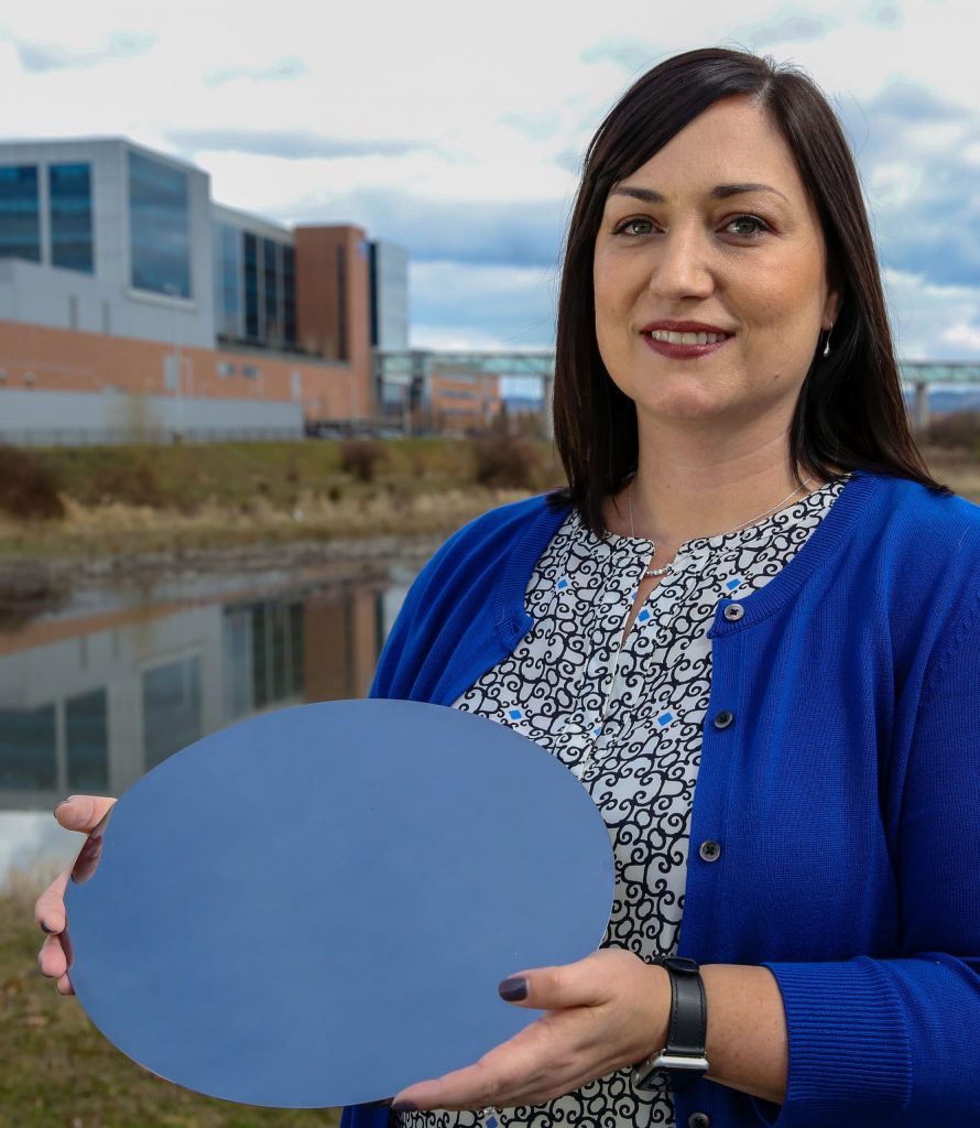 Fawn Bergen holding a wafer (what becomes many semiconductor “chips”).