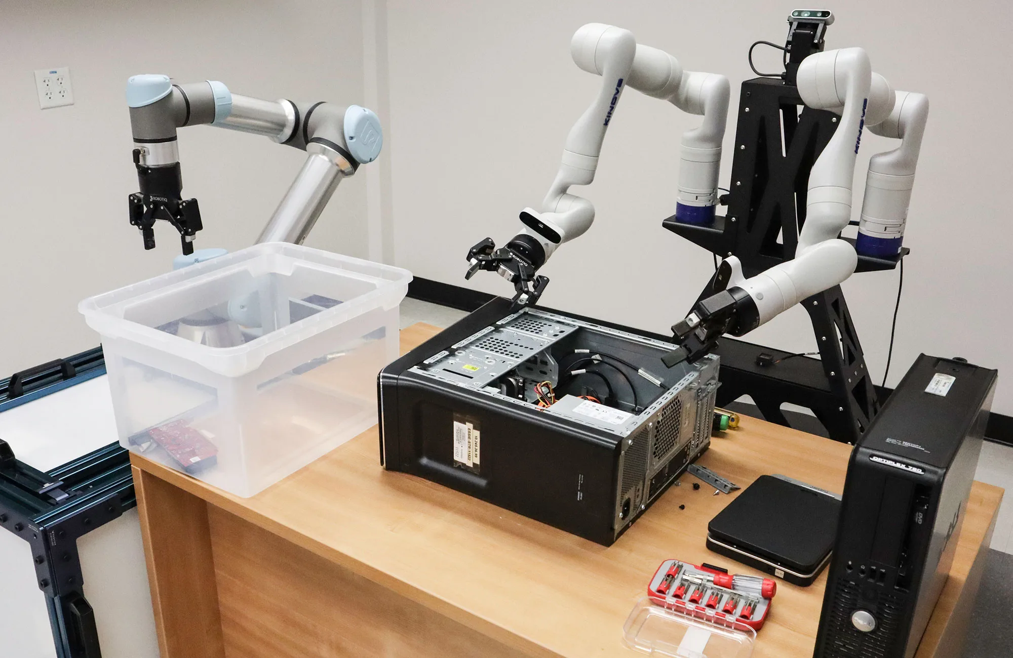 A robot prepares to remove components from a desktop computer