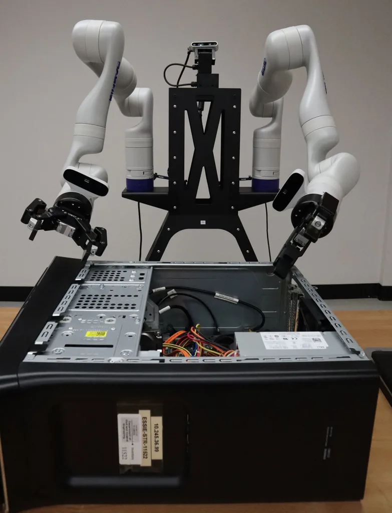 A robot prepares to remove components from a desktop computer.